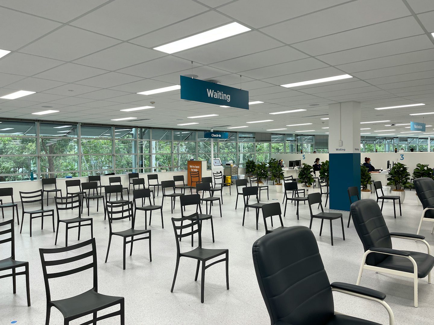 Rows of chairs in a modern clinic waiting area.